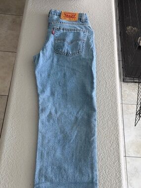 Levi's light blue denim jeans with tan leather label and red print